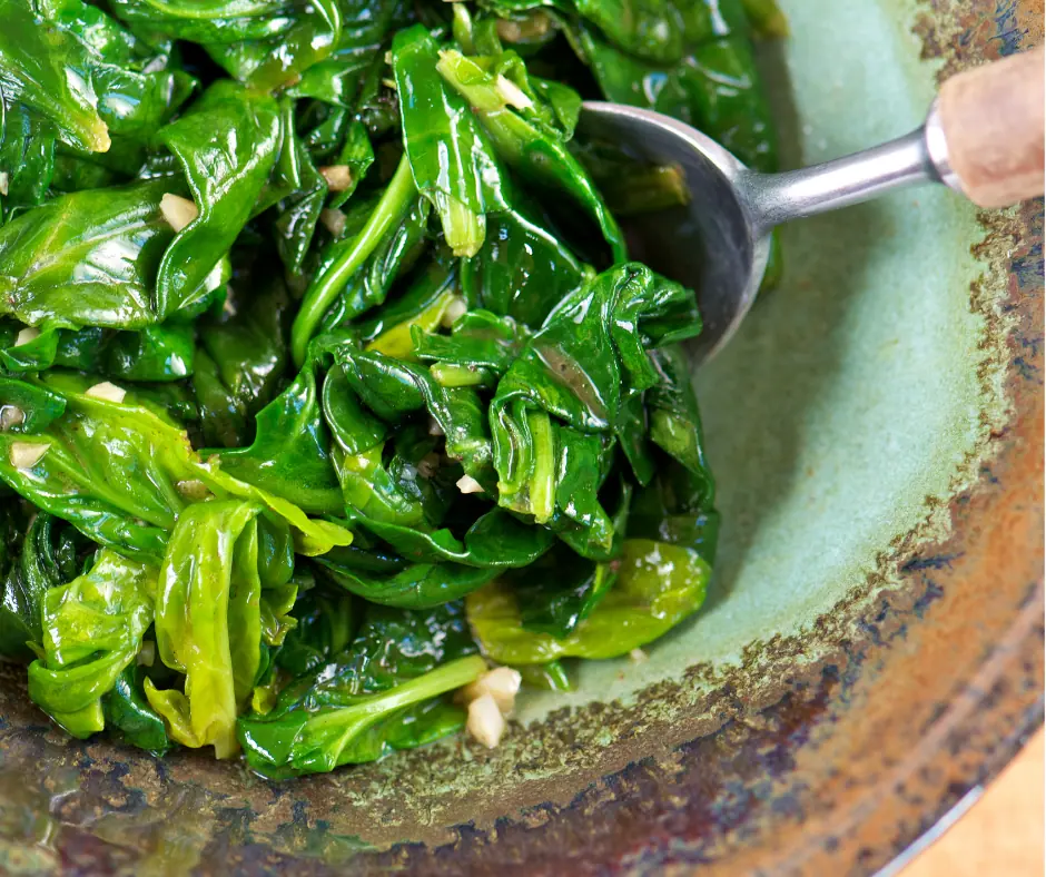a bowl of freshly harvested spinach sauted in olive oil